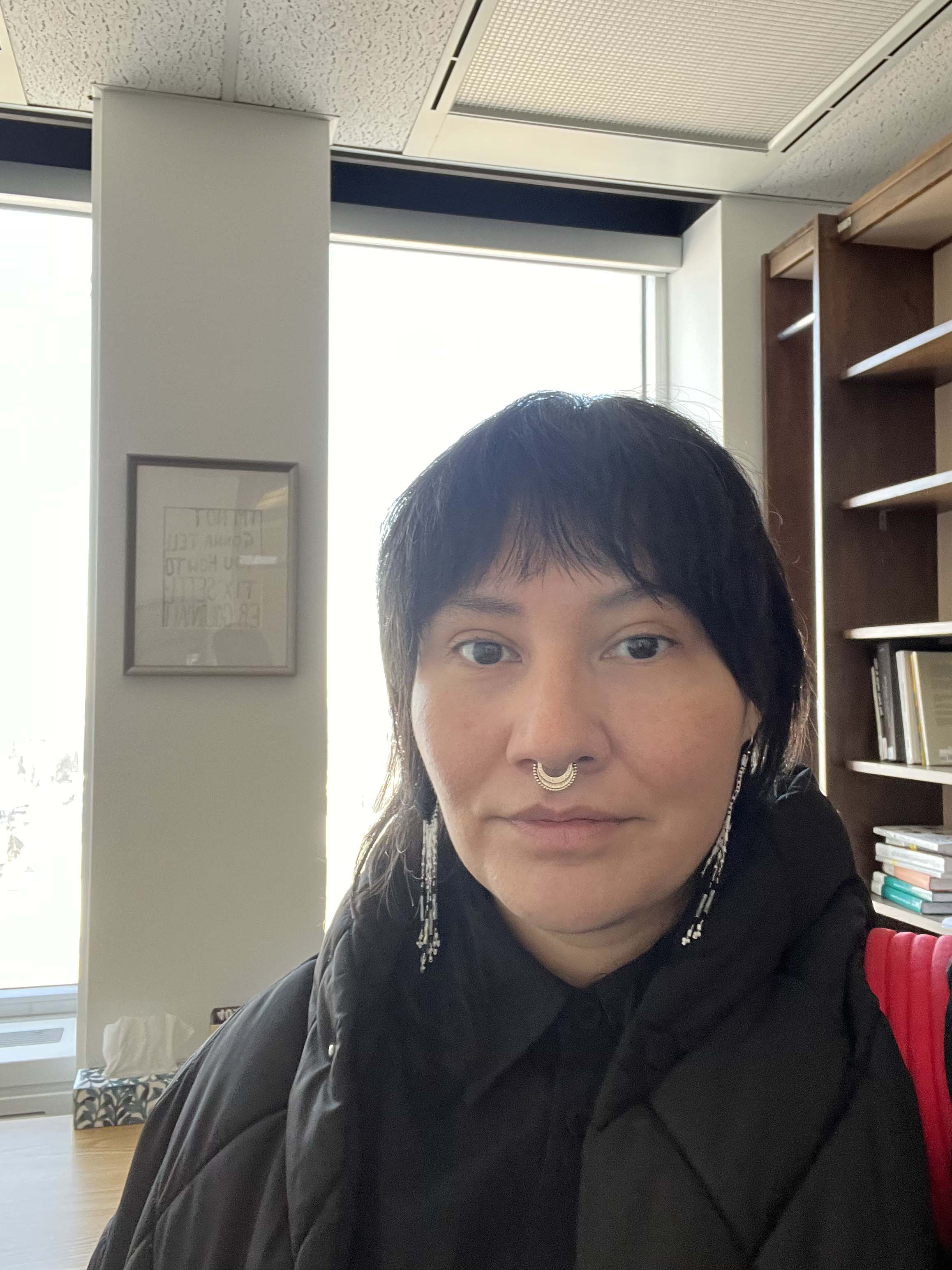 A portrait of the author in front of a window 