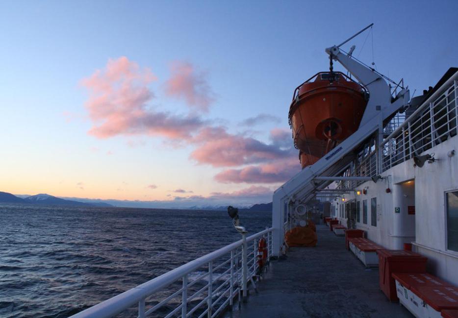 A view of the sunset over the water from the deck of a ferry in Alaska