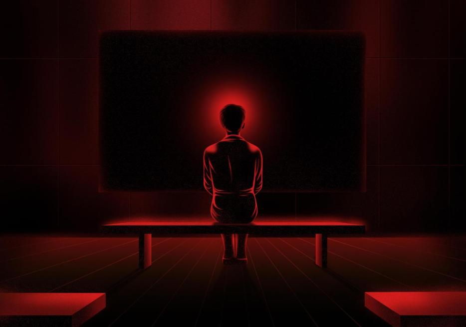 The back of a female figure sitting on a bench, with a red halo around her head, against a background of a dark projection screen.