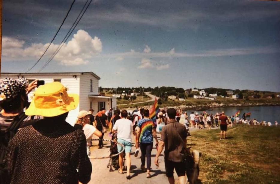 A group of people walking towards the beach 