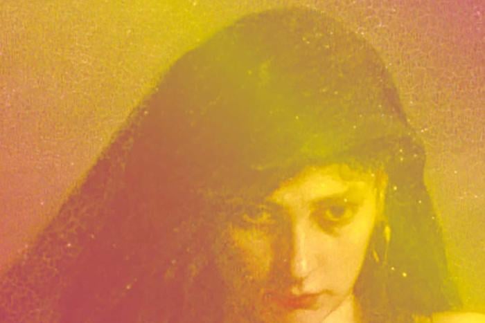 A woman staring down, with a yellow and pink cast 