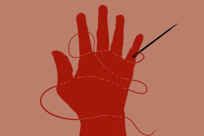 A red hand on a beige background, stitched through with thread. The needle rests on the pinkie finger 