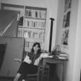 Image of young brunette woman sitting in a chair